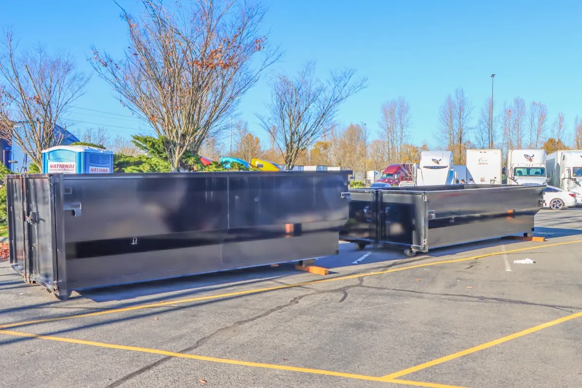 Professional dumpster rental service with roll-off container on residential driveway in Newmarket